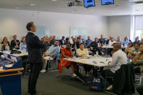 Filming corporate presentation for business conference with full audience