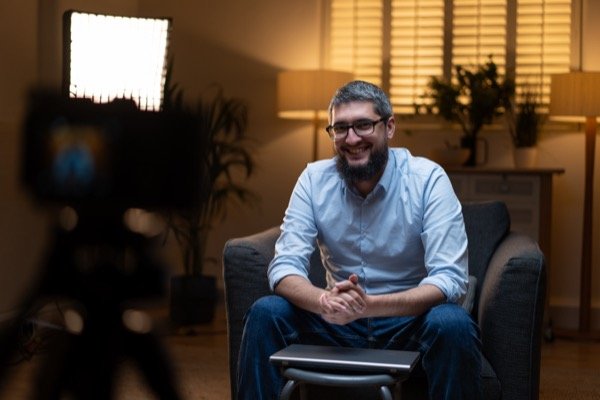 Filming testimonial interview with warm cinematic lighting at home location