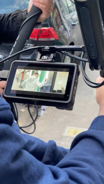 Monitoring footage on external field monitor during on-location video shoot