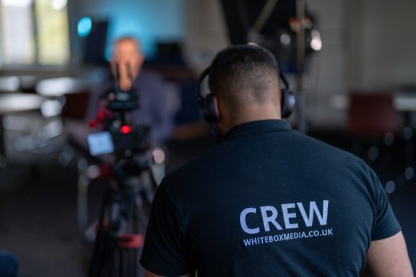 White Box Media crew member operating camera during corporate interview